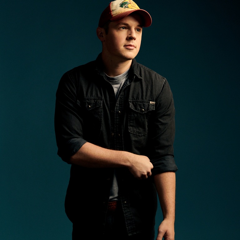 TRAVIS DENNING DOESN’T LEAVE HOME WITHOUT HIS BASS PRO SHOPS HAT.